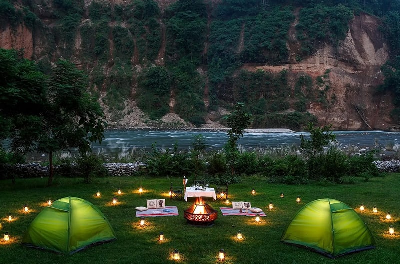 Candlelit forest dining under stars